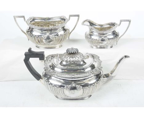 A 19th Century silver plated three piece tea setThe teapot with an ebonised finial, gadroon leaf and shell cast border above 