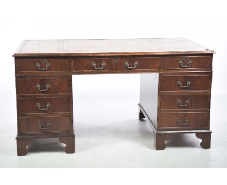 A reproduction mahogany twin pedestal writing deskThe rectangular moulded top with a gilt tooled leather writing surface abov
