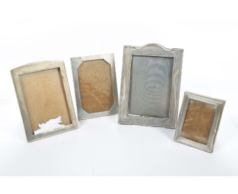 Four assorted silver easel photograph framesTwo with engine turned decoration and two plain examples, the largest 18cms high