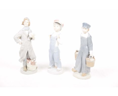 Three Lladro figuresTo include a young boy wearing a cap and dungarees, a young boy with two pails, and a young woman with a 
