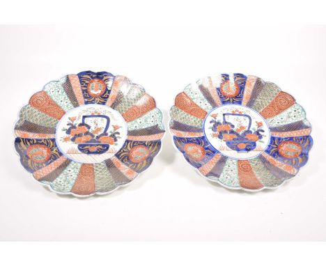 A pair of Japanese Imari chargers, Meiji period (1868 - 1912)Of circular form with scalloped rim, the central white glazed ro