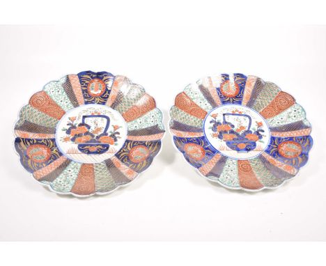 A pair of Japanese Imari chargers, Meiji period (1868 - 1912)Of circular form with scalloped rim, the central white glazed ro