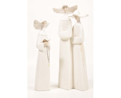 Two Lladro figurines of nunsTo include single nun with rosary reading a book, height 20cms, second model of two nuns with arm