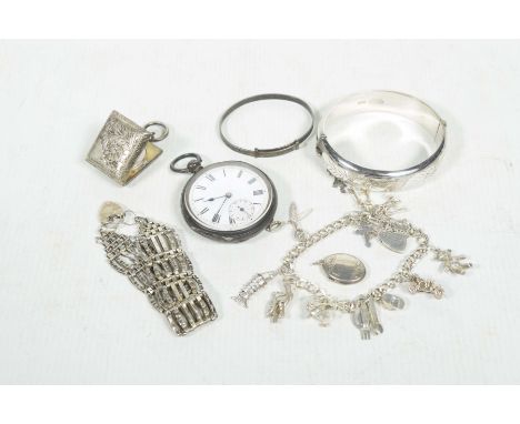 A collection of silver itemsTo include a sterling silver bangle, a gatelink bracelet, an oval pendant, a silver and white met