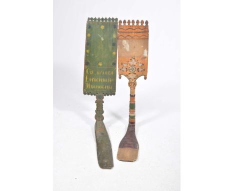 Two early 20th Century painted Hungarian weaving paddles Each with a shaped and serrated top edge above a painted panel, date