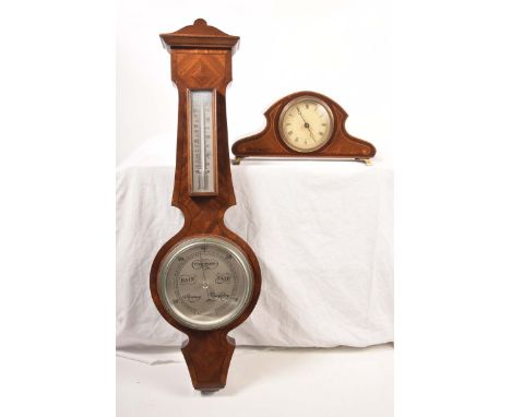 An Edwardian mahogany inlaid mantel clock8cm cream enamel dial with Roman numerals, the arch shaped top with inlaid decoratio