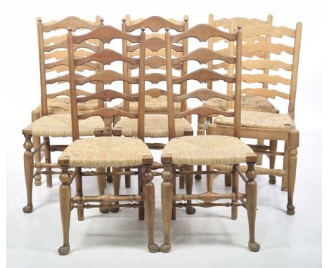 Eight rush seated beech wood ladder back kitchen chairs, 20th CenturyEach with an envelope rush seat and ring turned cross st