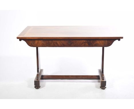 A George IV mahogany library tableThe rectangular feathered mahogany top with maple cross banding above a single frieze drawe