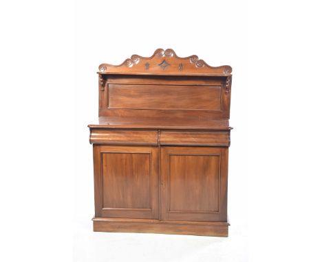 A Victorian mahogany chiffonier The raised back with carved decoration and serpentine shelf, above two hidden scroll front fr