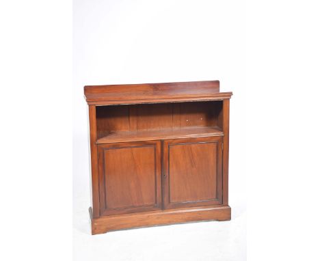 A Victorian mahogany bookcaseThe rectangular top above a book shelf recess and two panelled cupboard doors enclosing a single