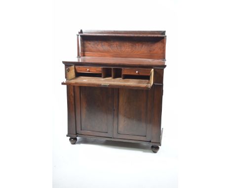 An unusual early 19th Century mahogany chiffonier secretaire sideboardThe raised back with a single shelf supported on two ta