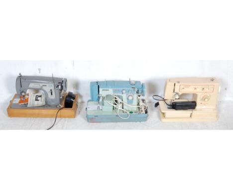 A group of three vintage retro 20th century electric sewing machines. The collection comprising of a Frister &amp; Rossmann m