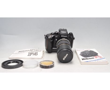 a vintage retro 20th century Nikon F4 35mm SLR camera / photographing camera serial number 2331848 having Nikon DP-20 view fi