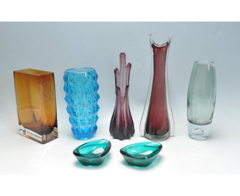 A collection of six retro vintage 20th century studio art glass comprising of a faceted blue glass vase, an amber glass vase,