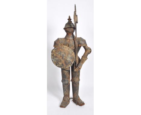 A large antique style advertising point of sale Medieval metal half size Knight wearing traditional suit of armour with helme