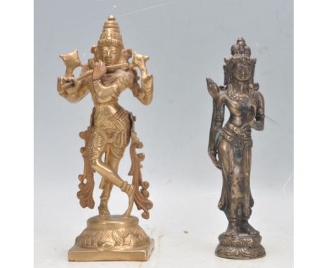A pair of early 20th century cast metal and brass deity figures to include a south Indian Krishna posed in typical depiction 