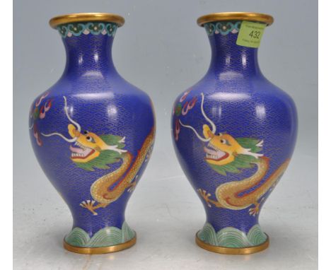 A pair of vintage 20th century Chinese Cloisonné vases having a gilt and cobalt blue background with polychrome decoration of