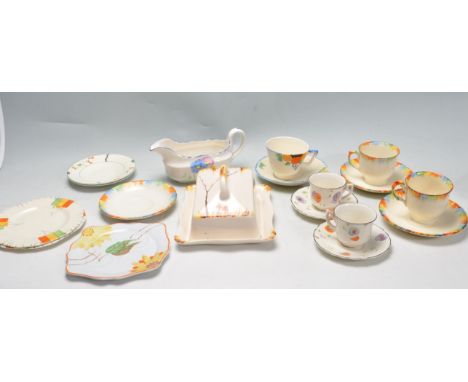 A collection of early 20th century hand painted Art Deco ceramic ware to include tea cups, saucers, cake plates, serving plat