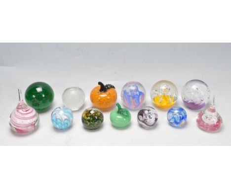 A large collection of approximately 26 vintager retro 20th century studio glass paperweights to include Caithness, Stuart Cry