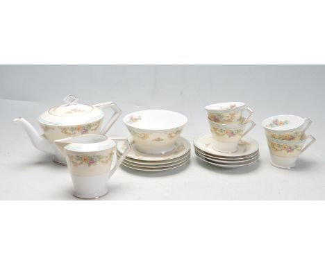 A vintage 20th century Noritake china tea service comprising of cups, saucers, trios, sugar bowl, creamer jug and tea pot. Th