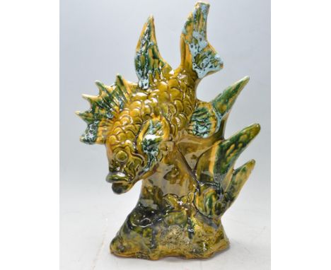 A retro vintage l1970s 20th century glazed ceramic Chinese oriental fish ornament. The ornament is coloured in a dark green c
