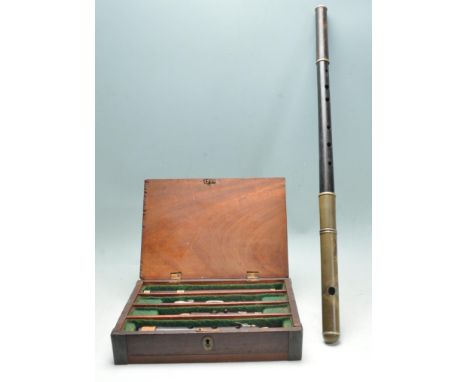 An early 20th century wooden clarinet musical instrument within a fitted case together with an ebony fife flute. Measures 67c
