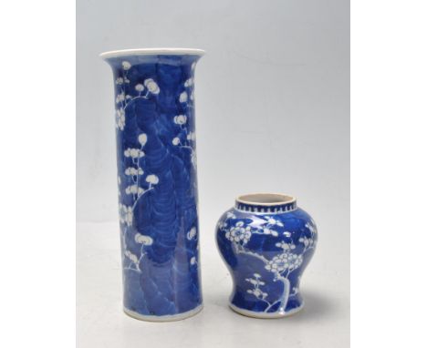 A 19th century Chinese oriental ceramic porcelain sleeve vase of cylindrical form with shaped rim in prunus with blue Chinese