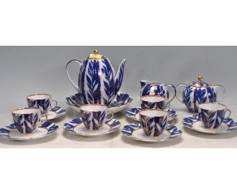 A vintage 20th Russian china tea service having blue and gilt decoration with foliate detailing. Collection includes cups and