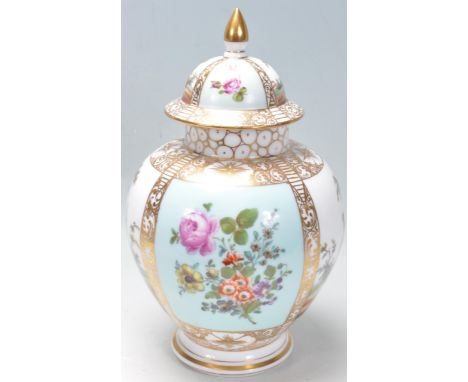 A 20th century hand painted ceramic lidded vase / jar / ginger jar in the manner of Meissen of a bulbous form with floral and