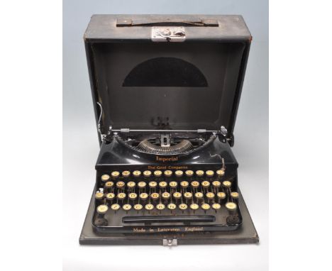 A vintage 20th century Imperial The Good Companion portable typewriter having a black frame with gilt detailing. Comes in har