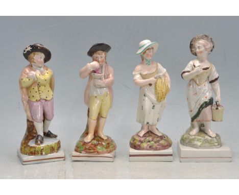A group of four 19th century Victorian Staffordshire ceramic porcelain four seasons figurines. The group comprising of spring