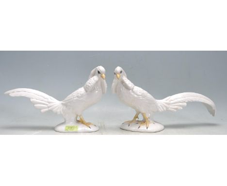 A pair of vintage 20th century Italian ceramic white crested cockatoo figurines having polychrome decoration raised on a natu
