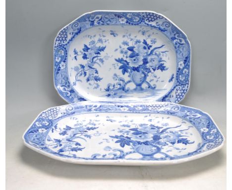 A pair of early 20th century delft blue and white ceramic meat platters featuring birds and a vases to the basins and borders