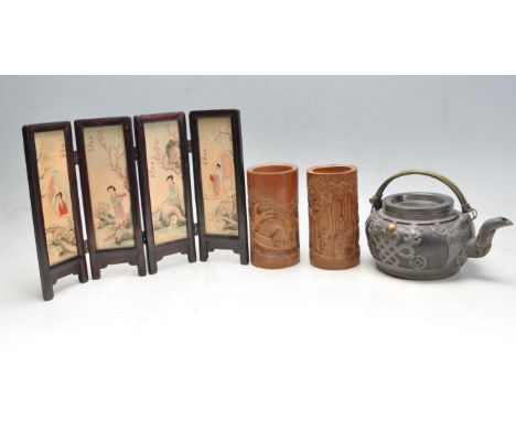 An early 20th century Chinese teapot with Chinese knot symbols to the body, alongside two carved bamboo&nbsp; brush pots and 