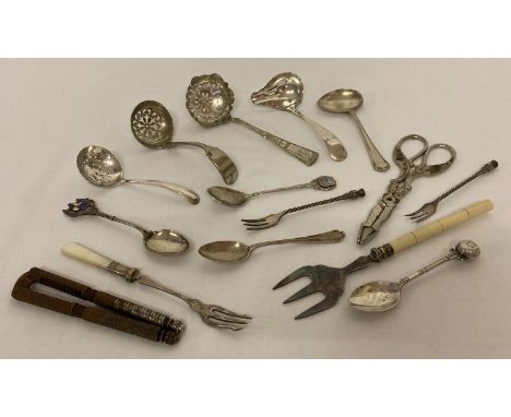 A collection of vintage silver and silver plated cutlery items. To include: sugar sifters, pickle fork, tea spoons and feedin