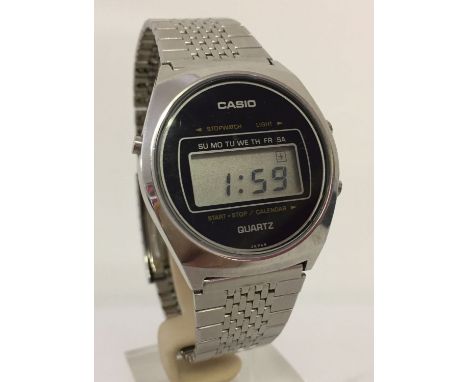 A vintage 1976 Casio watch with stainless steel strap and digital display. In working order.