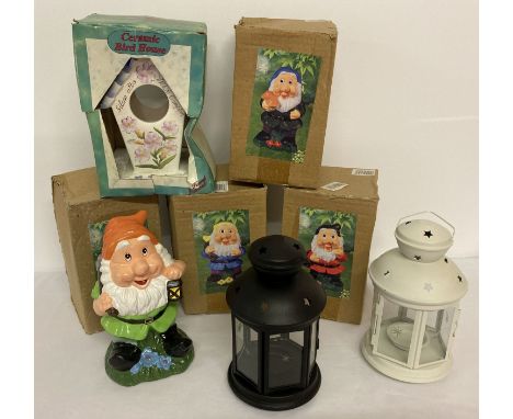 A collection of modern garden ornaments. Comprising: 4 boxed pottery garden gnomes, 2 metal hanging lanterns with glass panel