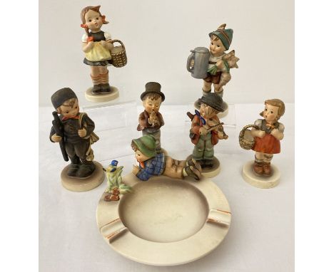 6 West German Goebel ceramic Hummel figurines together with an ashtray. Some pieces a/f. To include: Chimney Sweep, For Fathe