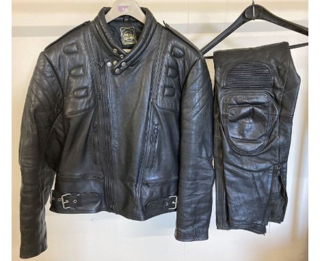 A black leather motorbike jacket and matching leather trousers by J &amp; S Accessories. Ribbed elbows, zipped pockets to fro