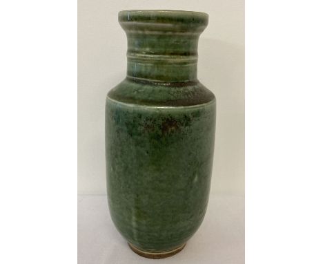 A dark green glazed ceramic vase with ridged neck. Approx. 18.5cm tall.