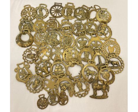 A collection of vintage horse brasses in varying sizes.