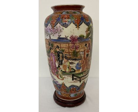 An oriental design ceramic vase depicting scenes of oriental ladies relaxing in a garden. Raised hand decoration to trees and