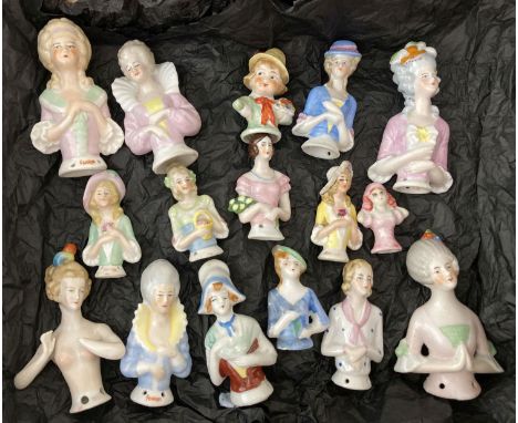 A collection of 16 vintage ceramic half dolls, in varying sizes.
