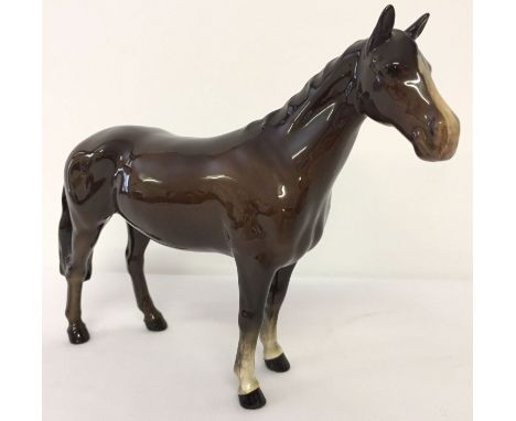 A Beswick ceramic Huntsman's Horse, model #1484, in brown gloss finish. Designed by Arthur Gredington, with circular backstam