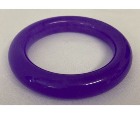 A lavender jade bangle. Approx. 8.75cm diameter, 6.25cm inner diameter.