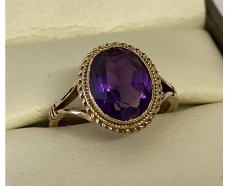 A 9ct gold 1.5ct amethyst set dress ring. Bezel set stone with rope decoration to mount. Total weight approx. 2.7g.