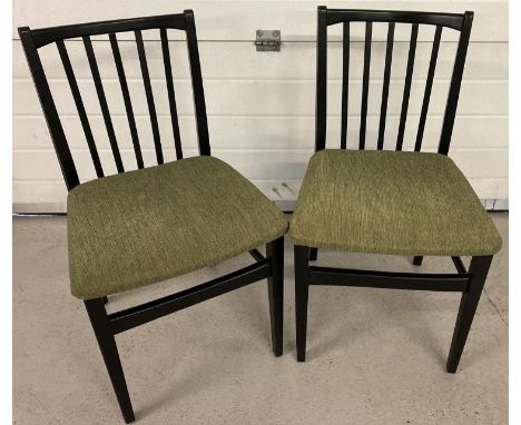 2 retro black painted wooden stick back style kitchen/dining chairs with green upholstery seats.