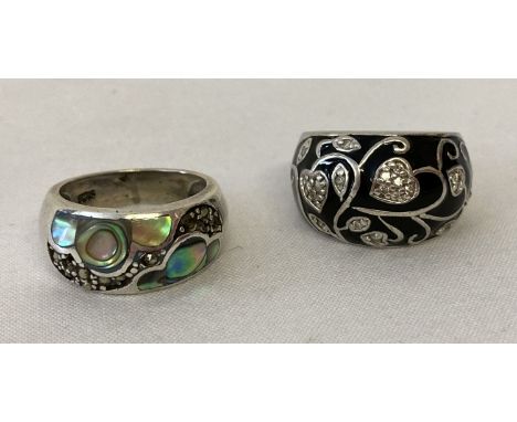 2 silver dome style dress rings. A black enamel floral design set with clear stones. Together with a paua shell and marcasite