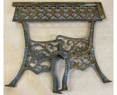 A pair of cast iron bench ends and back plate. Floral and scroll decoration to ends. With lattice design to back. Bench ends 