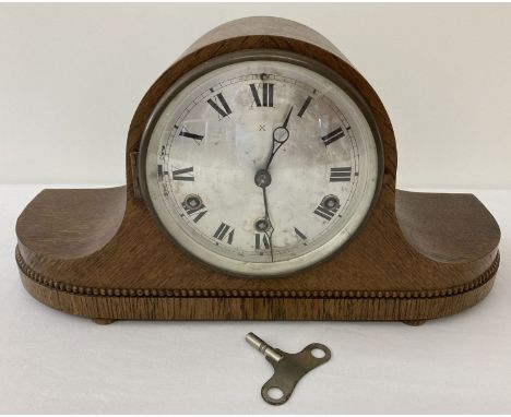 An Art Deco dark oak cased H.A.C make, German, Westminster chime mantle clock. With beaded detail and bun feet. Complete with